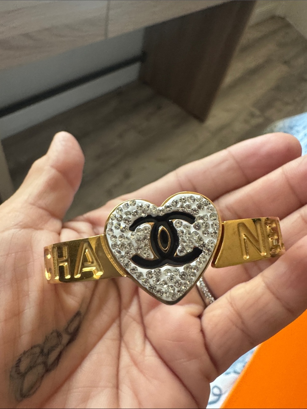 CHANEL Gold-Tone Heart Logo Crystal Bracelet with Black Accents